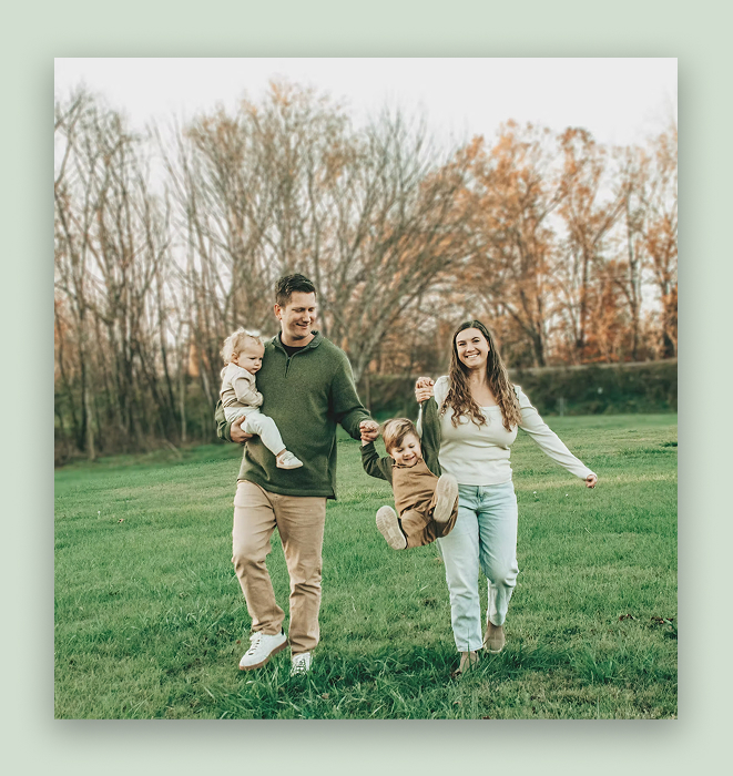 the owners of playland pals on some grass walking with their children